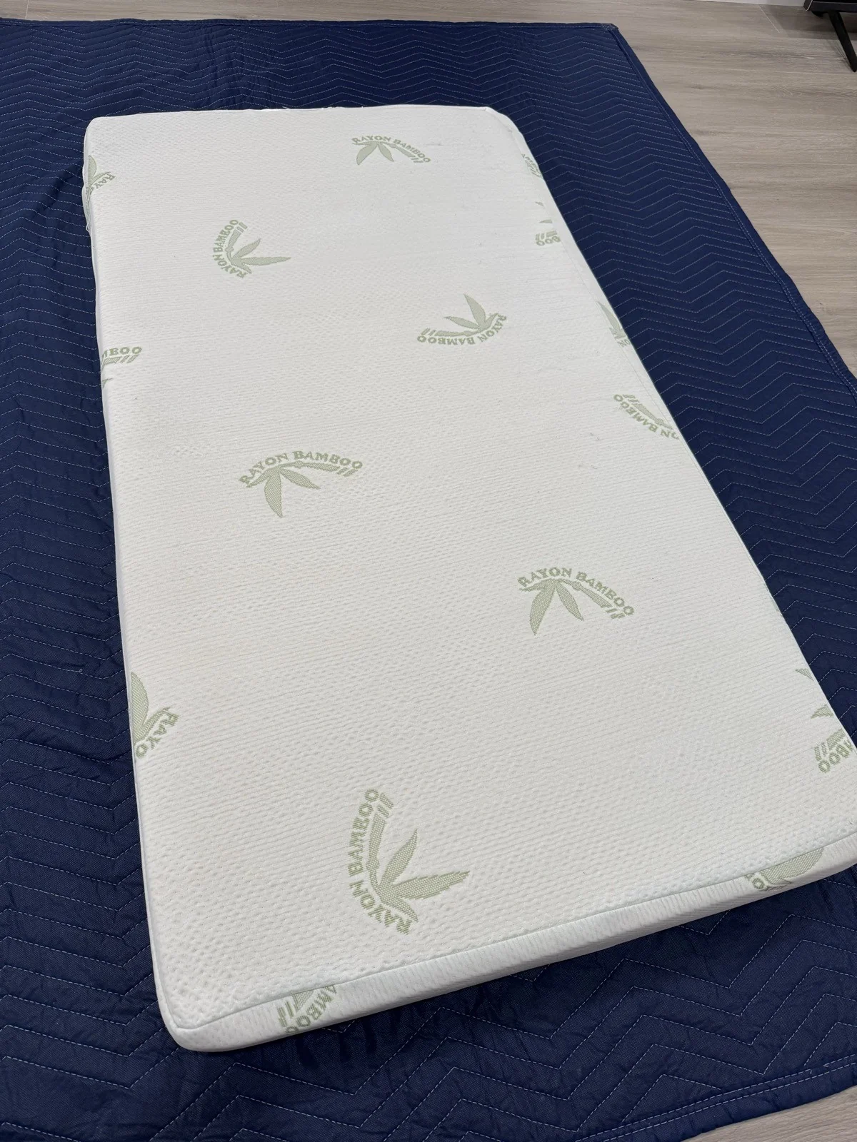 The mattress after cleaning, resting on a blue protective blanket